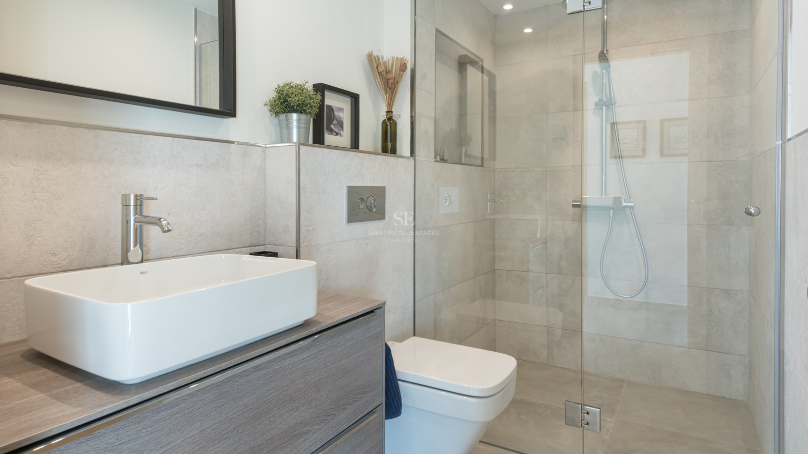 Contemporary bathroom featuring a white vessel sink, grey wood vanity, glass walk-in shower, and grey stone tiles.