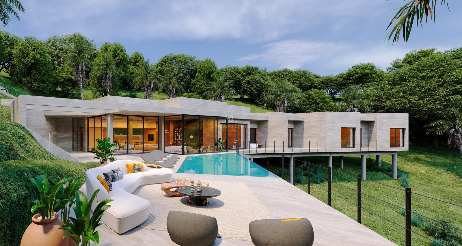 Contemporary villa terrace featuring a turquoise pool, white curved sofa, and glass walls against a lush hill.