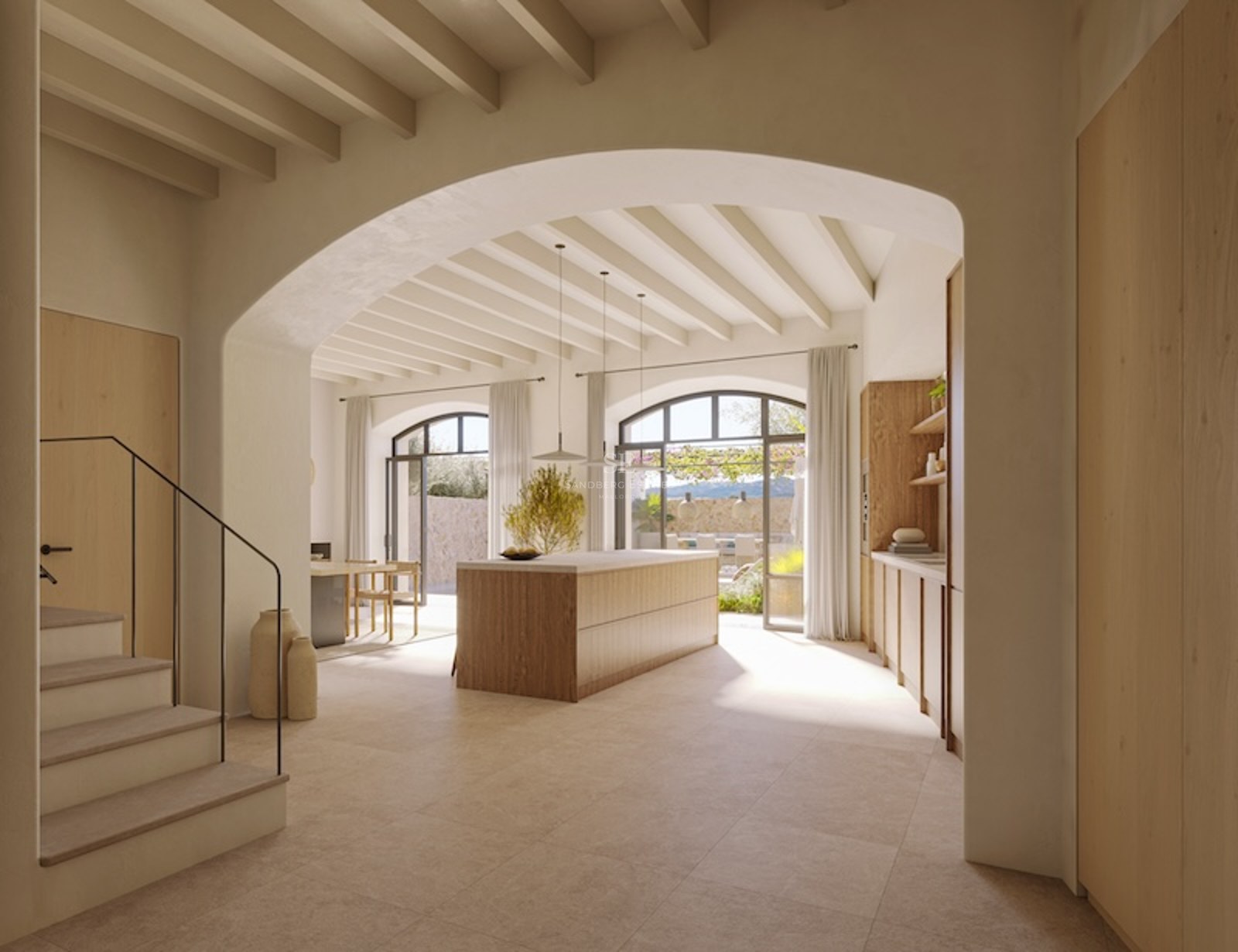 Minimalist kitchen with wooden island, beamed ceiling, and large arched doors opening to a terrace.