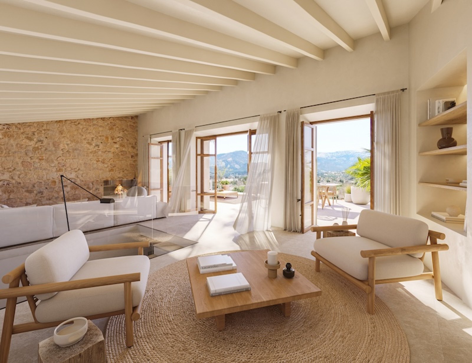 Spacious living room with wood beams, stone wall, and mountain views through open French doors.