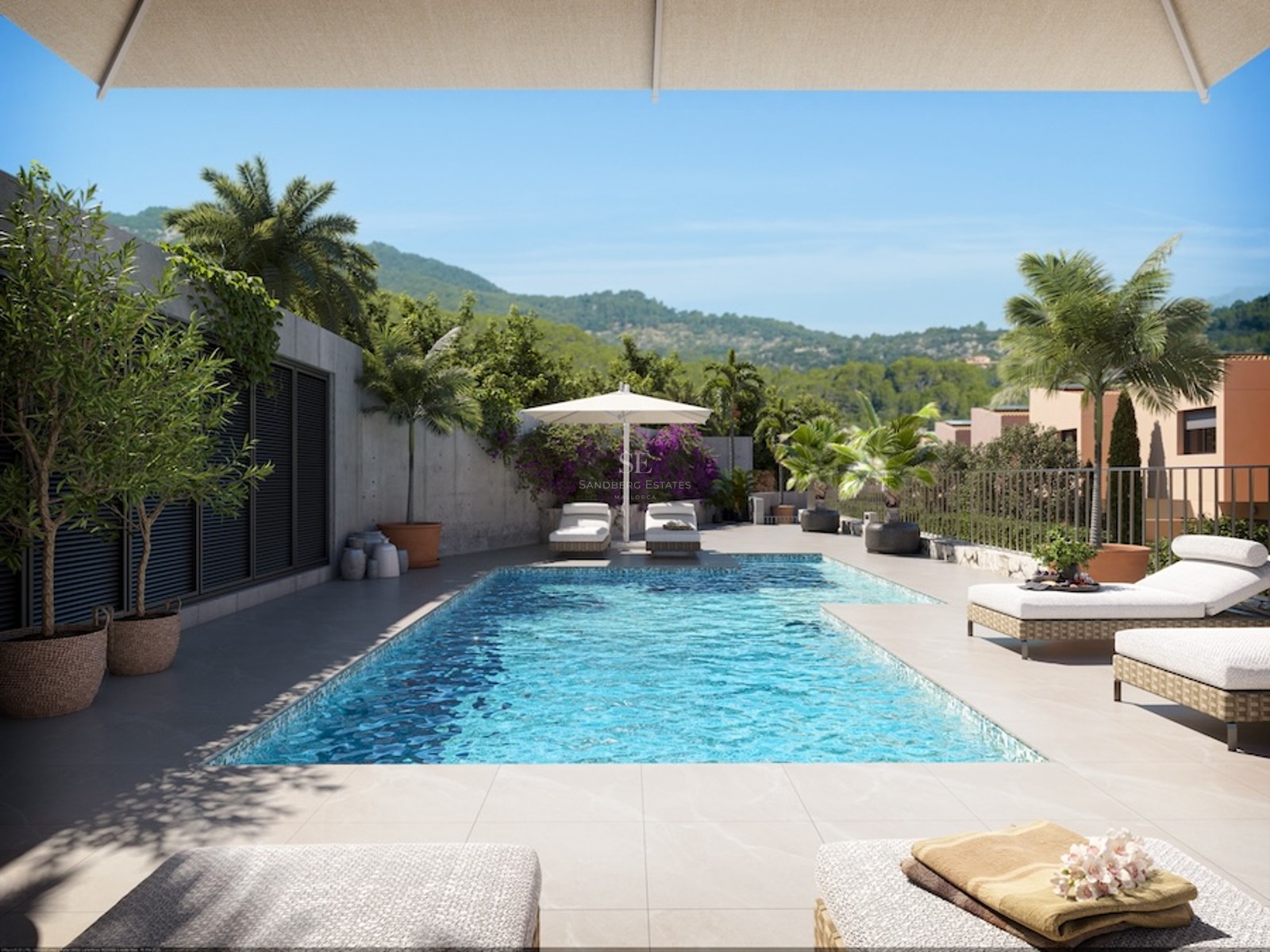 Sun-drenched pool area with white loungers, potted palm trees, and a view of lush green hills under a blue sky.