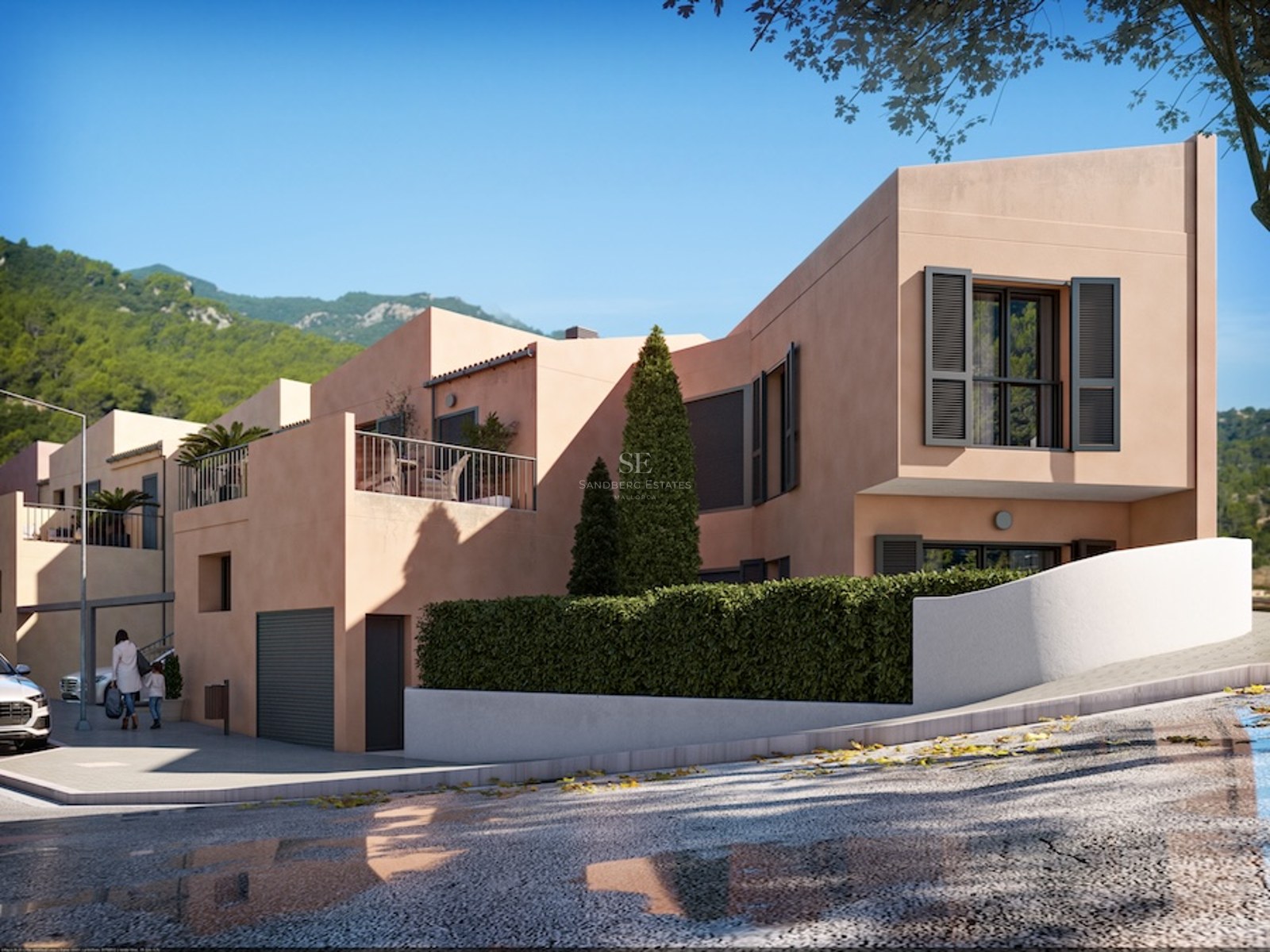Modern peach-colored villa with dark shutters, terrace, and lush greenery against a mountainous background.
