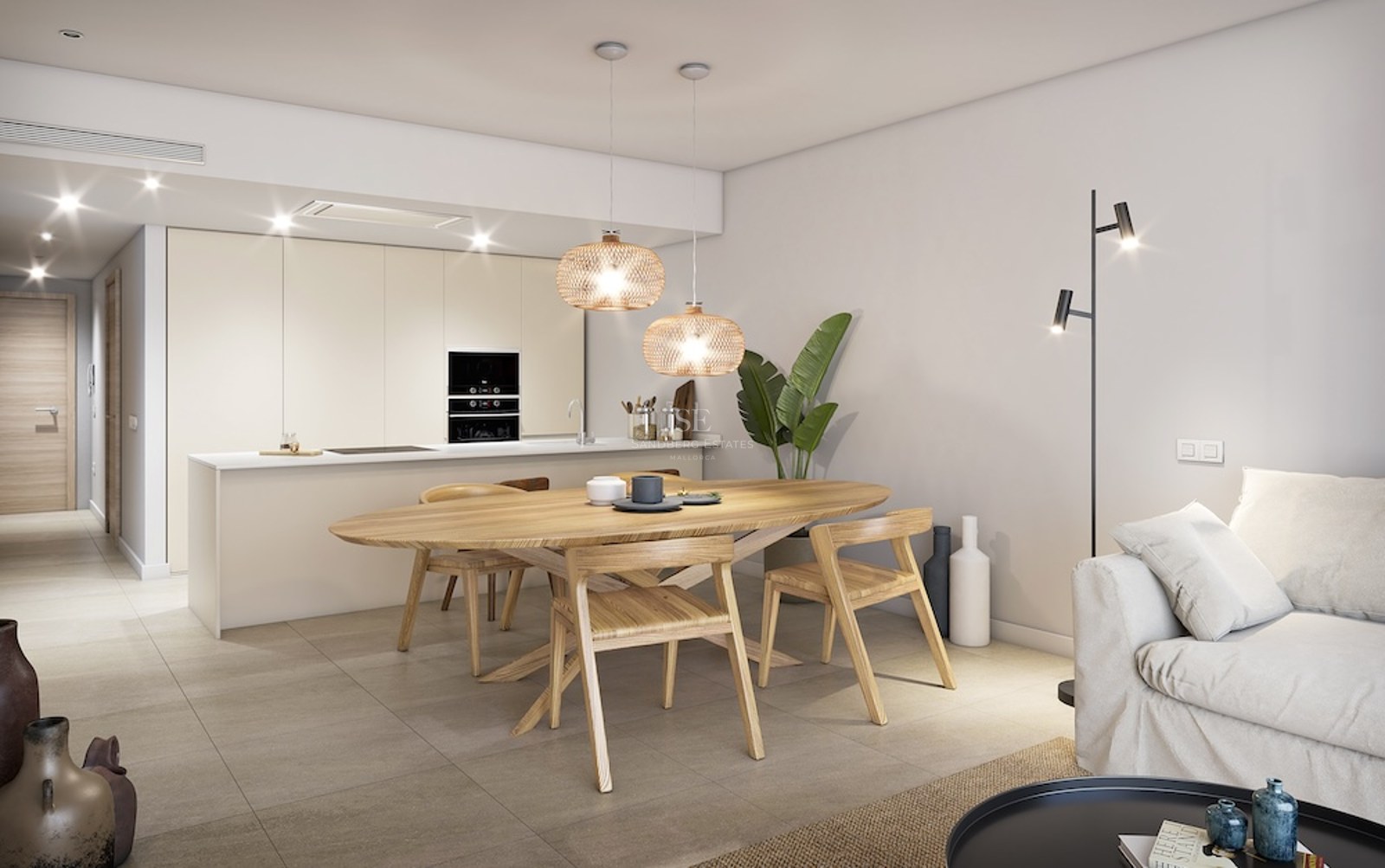 Comedor moderno con mesa de madera ovalada, lámparas de mimbre colgantes y cocina minimalista al fondo.