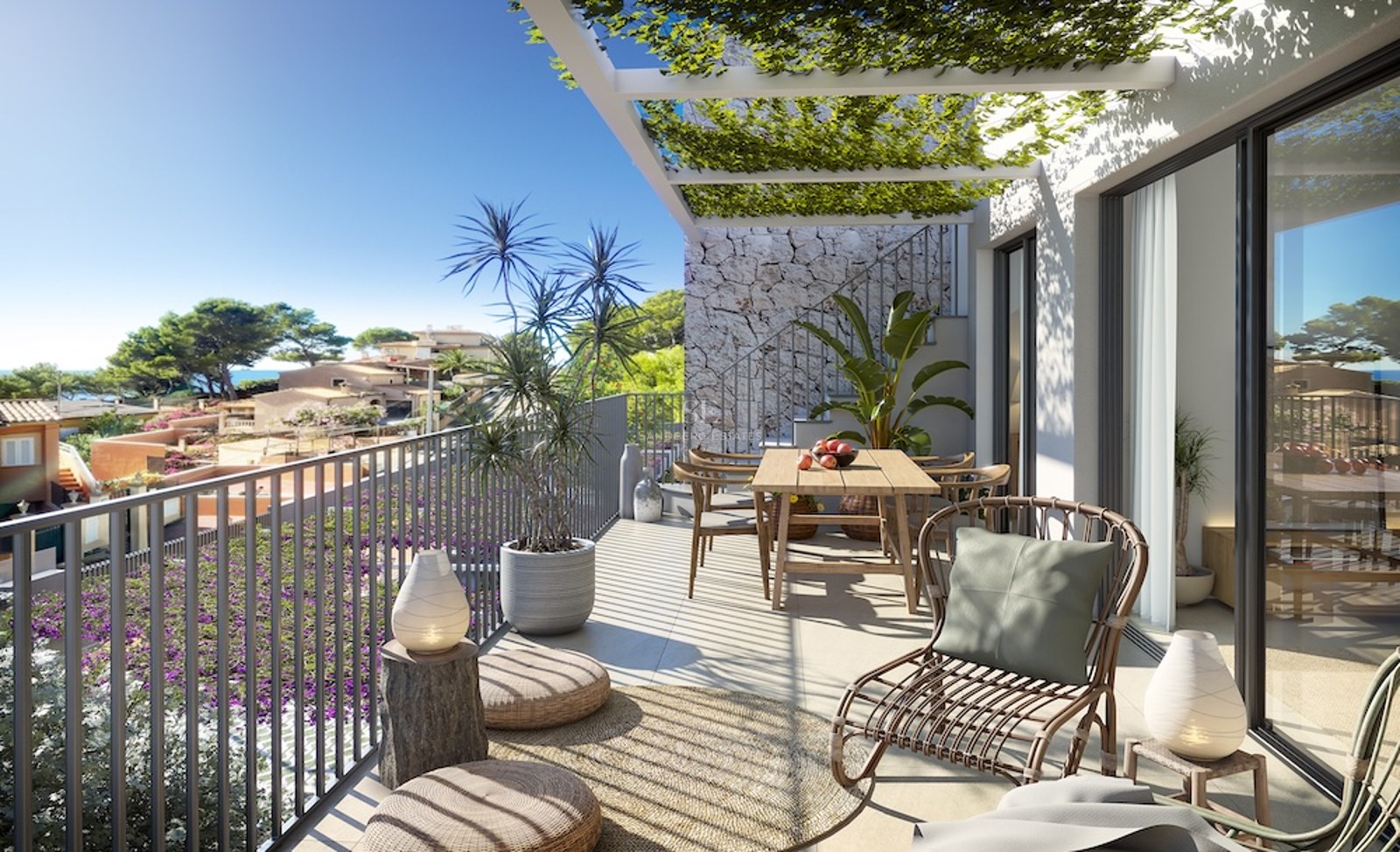 Terraza moderna y soleada con mesa de comedor de madera, sillón de mimbre y pérgola con plantas y vistas a la costa.