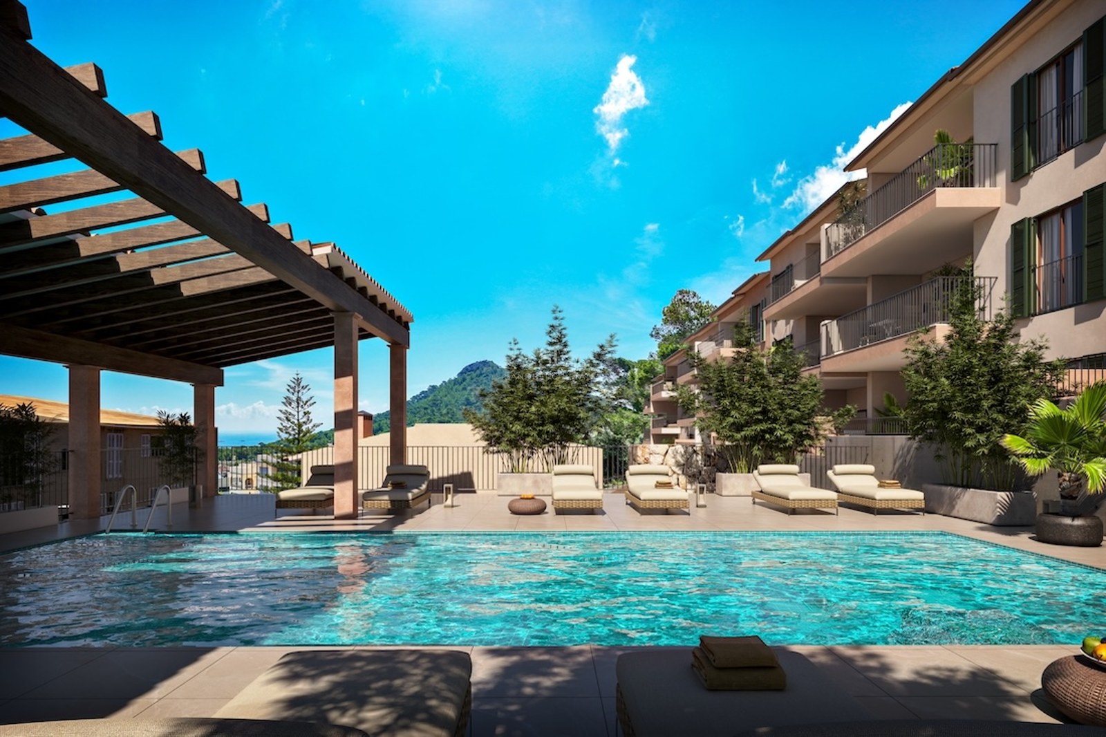 Turquoise swimming pool with sun loungers under a wooden pergola overlooking mountains and the sea under a blue sky.