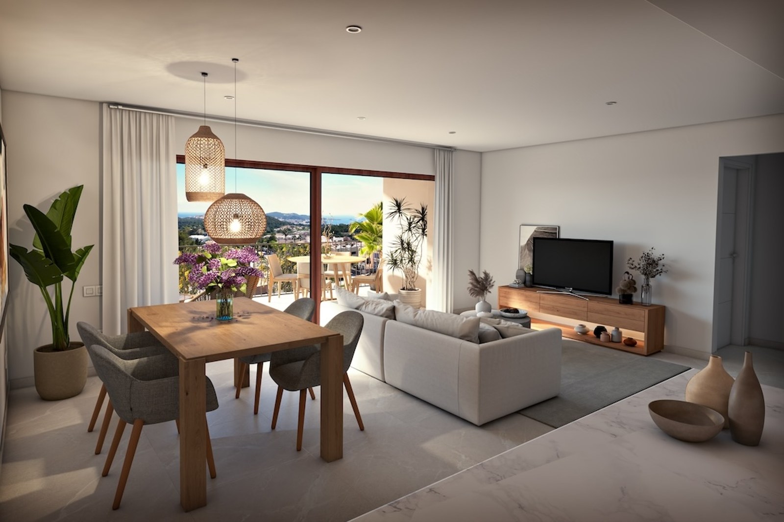 Salón comedor luminoso con muebles de madera, sofá neutro y grandes ventanales con vistas al mar y la costa.