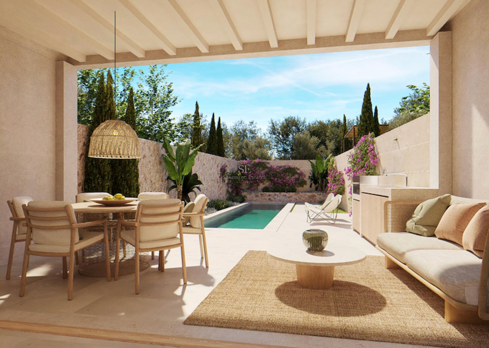 A covered terrace with a dining set, sofa, and outdoor kitchen, overlooking a long swimming pool and lush garden.