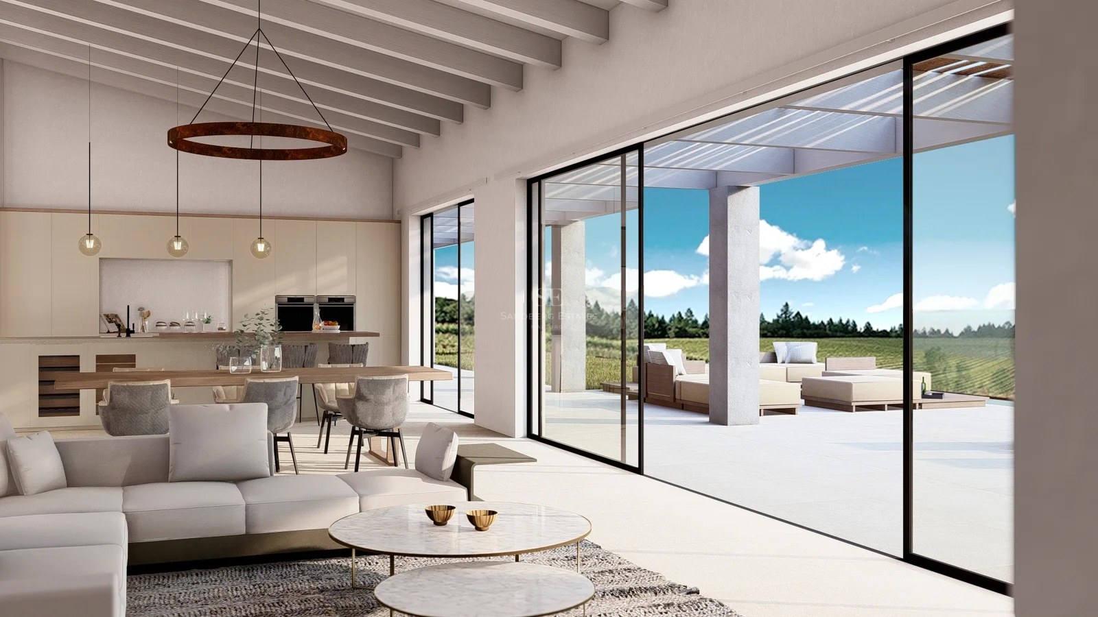 Bright living room with wooden beams, modern sofas, and large glass sliding doors opening to a sunny terrace.
