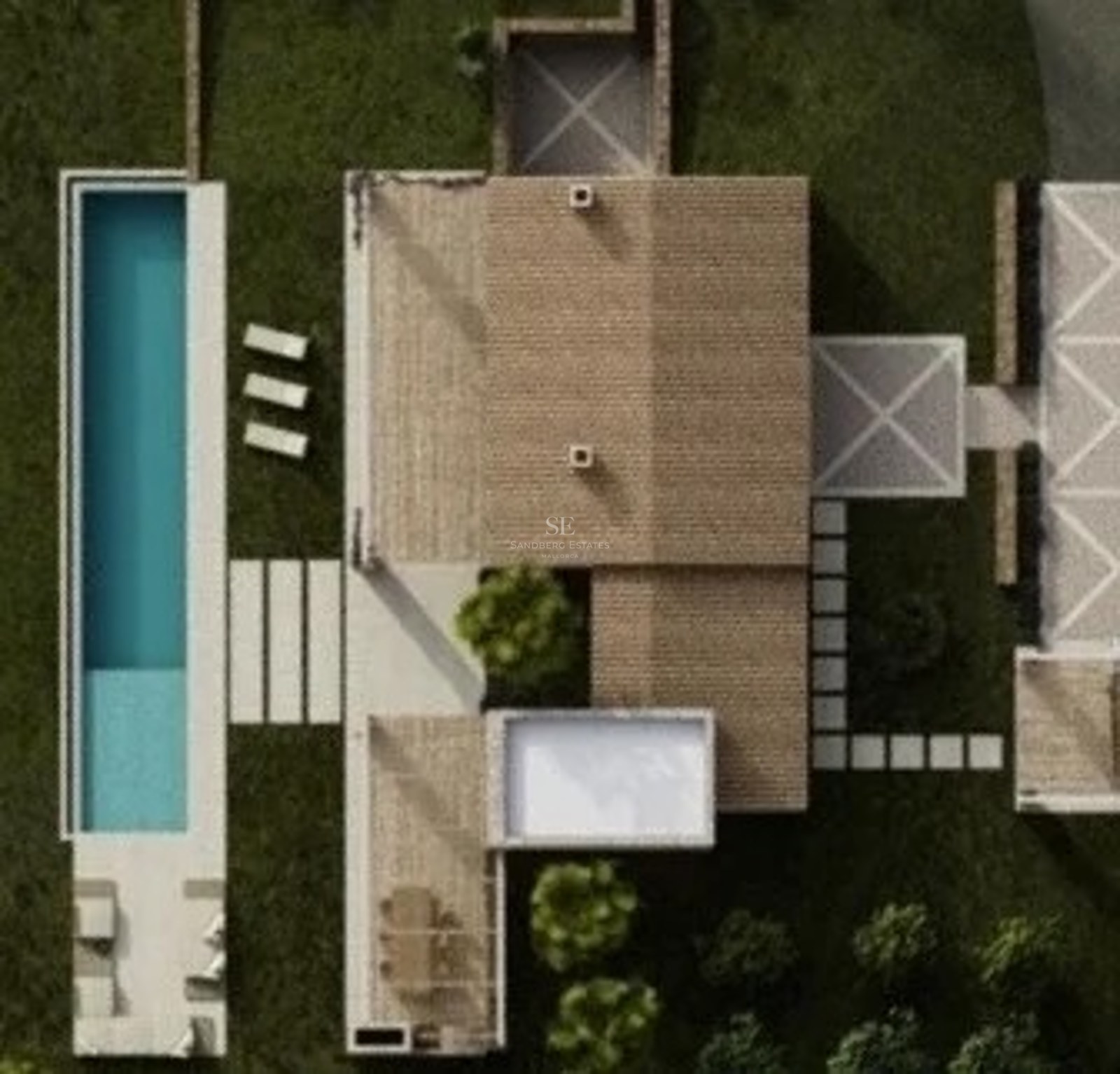Top-down aerial view of a luxury villa featuring a long turquoise pool, lush green lawn, and stone terraces.