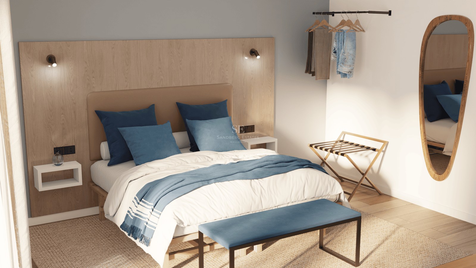 Minimalist bedroom featuring a light wood headboard, blue bedding, a designer bench, and an oval wall mirror.