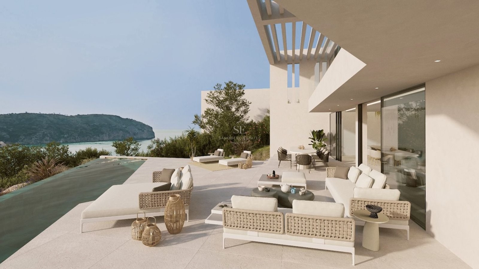 Modern white terrace with infinity pool, stylish outdoor furniture, and panoramic views of a Mediterranean bay.