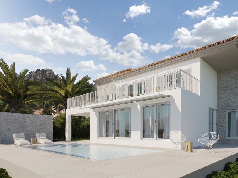 Villa moderne en pierre et enduit blanc avec piscine, palmiers et montagnes en arrière-plan sous un ciel bleu.