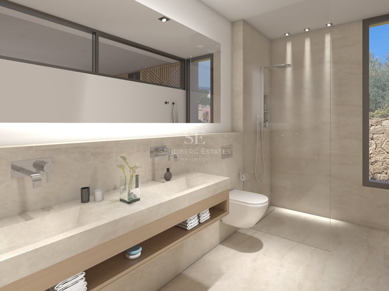 Salle de bain principale moderne avec double vasque en pierre, grand miroir rétroéclairé et douche vitrée.