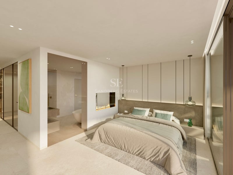 Chambre de maître lumineuse et moderne avec cheminée intégrée, salle de bain vitrée et baies vitrées.