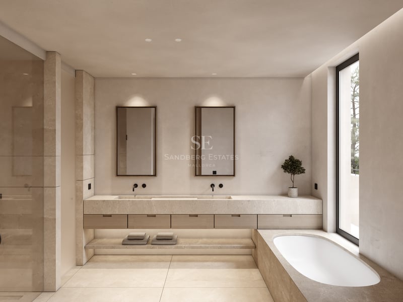 Salle de bain de luxe avec double vasque en pierre, baignoire intégrée et grande fenêtre lumineuse.