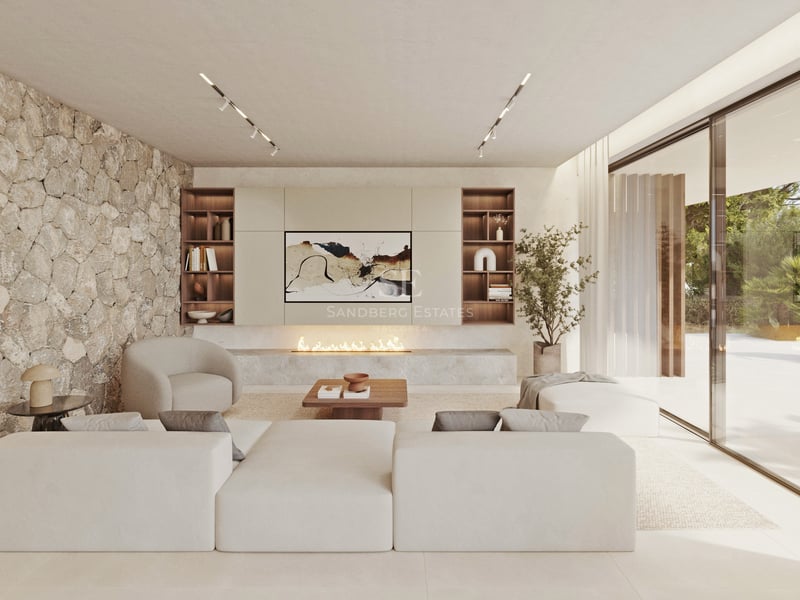 Salon moderne lumineux avec un grand canapé modulaire blanc, une cheminée linéaire et un mur d'accent en pierre naturelle.