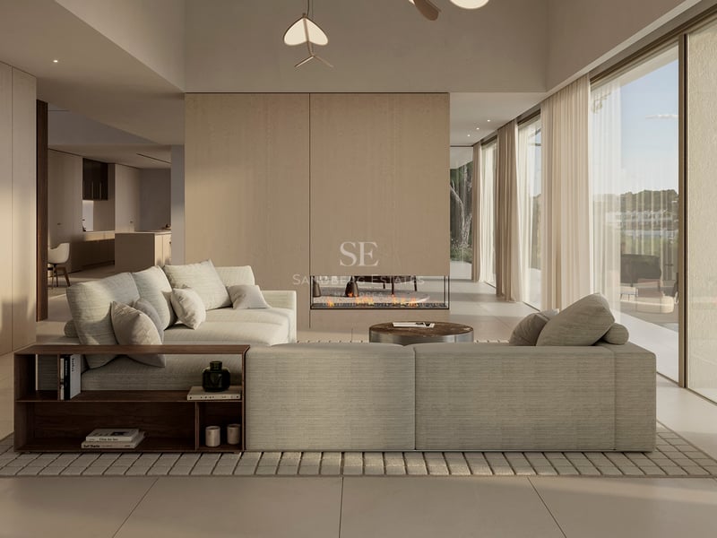 Salon de luxe minimaliste avec un grand canapé d'angle beige, cheminée linéaire et baies vitrées toute hauteur.
