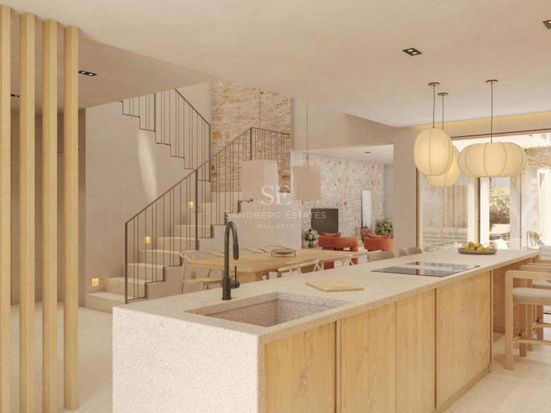 Îlot de cuisine moderne avec évier en pierre et finitions en bois, intégré à la salle à manger et à l'escalier.