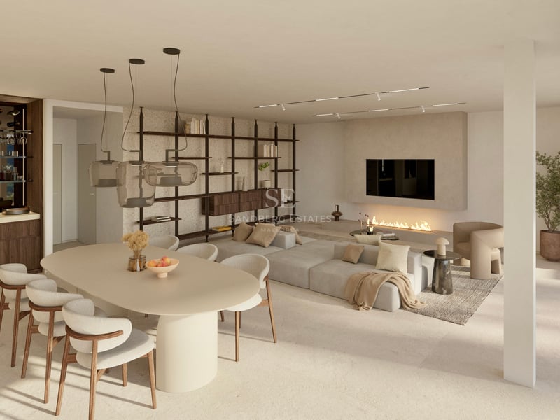 Salon moderne à plan ouvert avec grande table à manger, canapé modulaire, cheminée minimaliste et éclairage design.