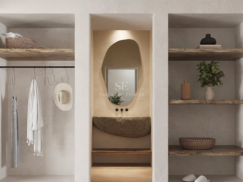 Dressing avec murs en plâtre texturé, étagères en bois brut, vasque en pierre naturelle et miroir organique.