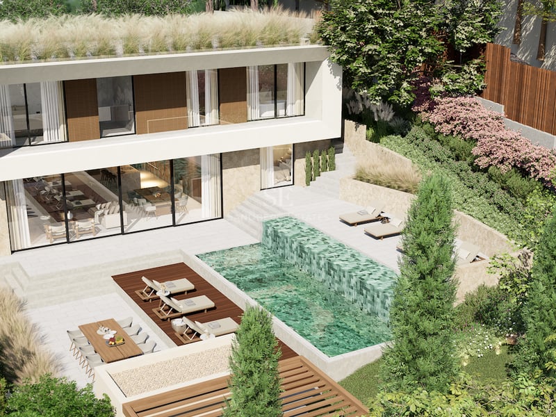 Vue aérienne d'une villa moderne en pierre et blanc avec piscine à plusieurs niveaux et jardin en terrasses.