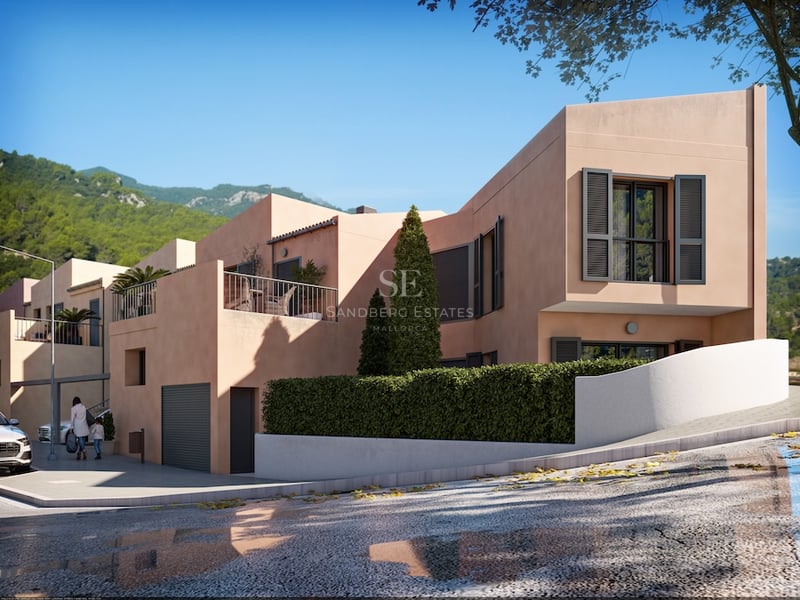 Villa moderne de couleur terre cuite avec volets sombres et terrasse devant un paysage montagneux.