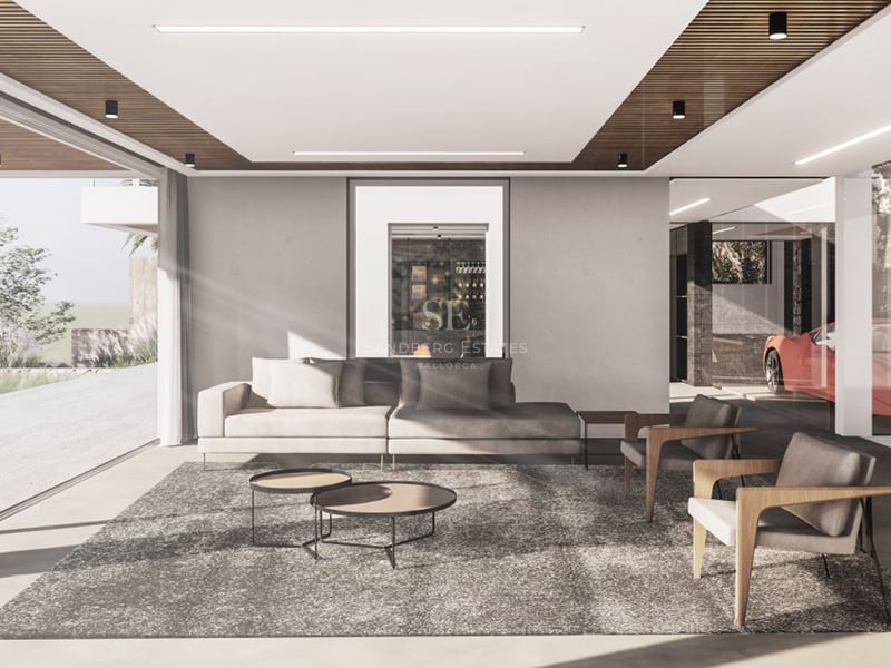 Salon minimaliste avec canapé gris, fauteuils en bois et grandes baies vitrées donnant sur l'extérieur.