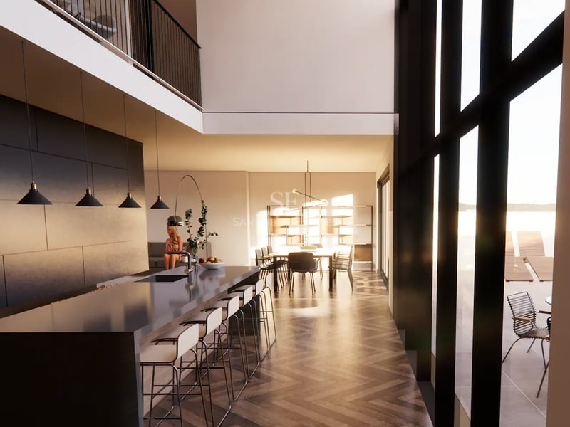Cuisine moderne avec îlot, parquet en point de Hongrie et plafond double hauteur avec grandes baies vitrées.