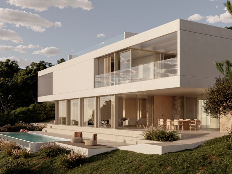 Villa blanche moderne sur deux niveaux avec baies vitrées et piscine à débordement à la tombée du jour.
