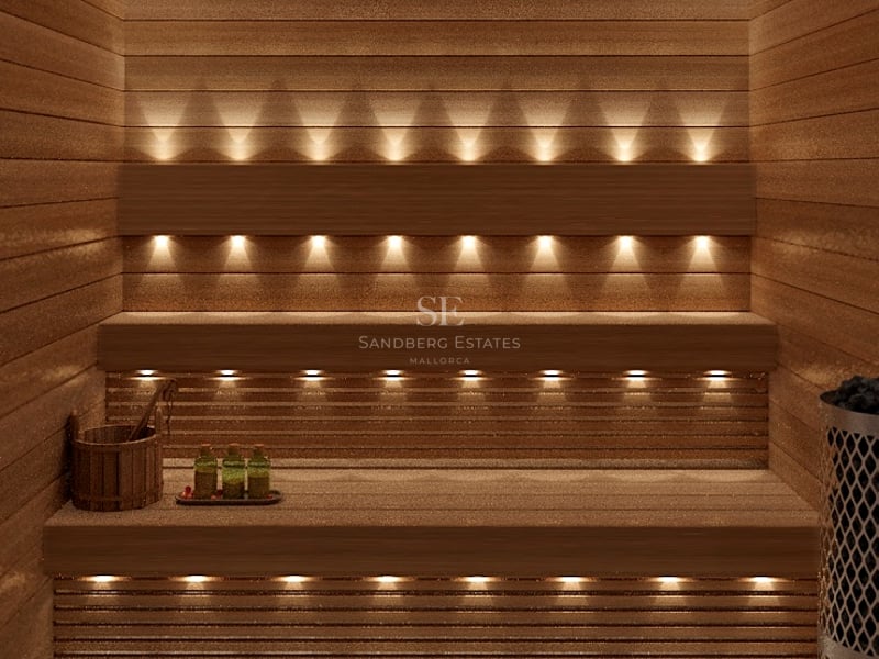 Intérieur d'un sauna en bois avec éclairage intégré chaleureux, bancs en bois et accessoires de bien-être.