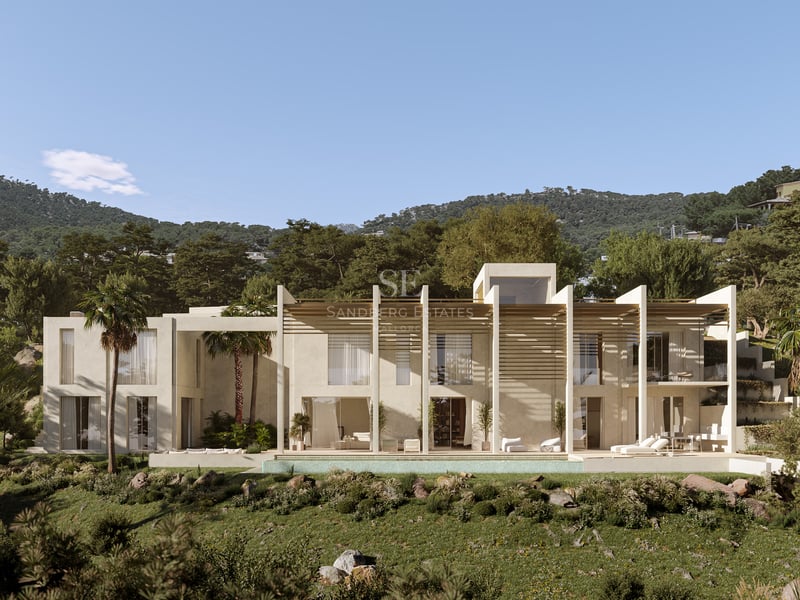 Villa contemporaine en pierre claire avec piscine à débordement, pergolas en bois et montagnes en arrière-plan.