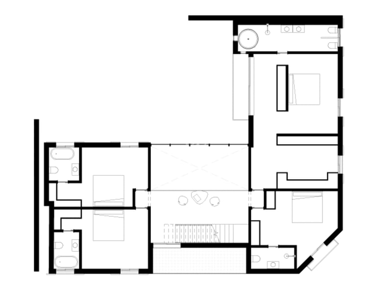 Plan architectural en noir et blanc montrant la disposition des chambres, salles de bains et espaces de vie.