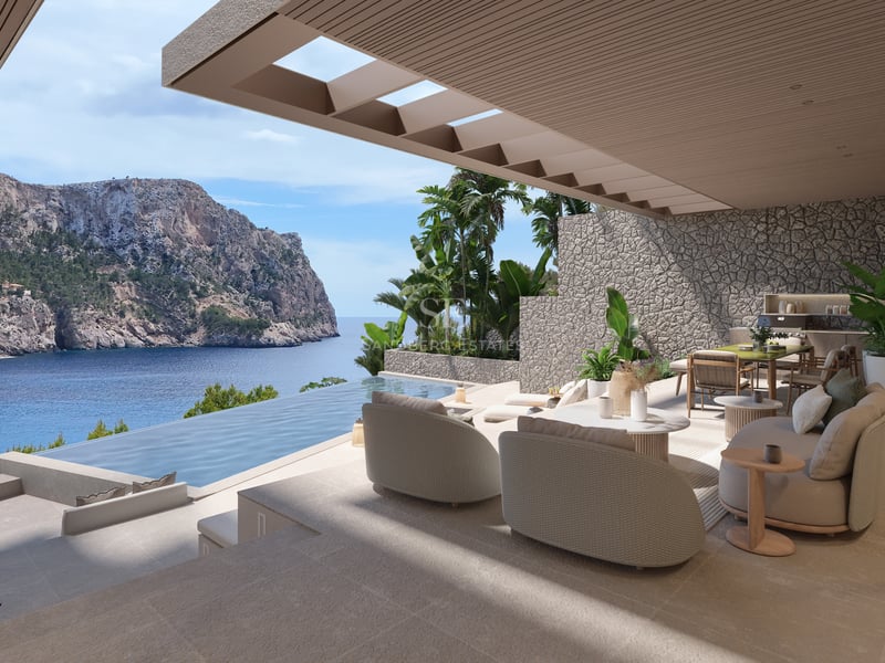 Terrasse couverte avec salon de designer et piscine à débordement offrant une vue sur la mer.