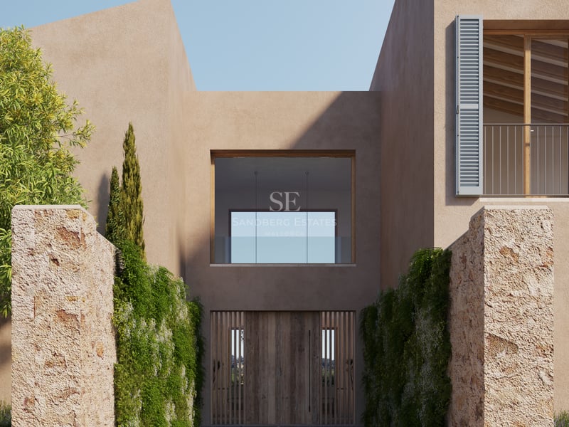 Entrée d'une villa moderne avec une grande porte en bois, des murs couleur sable et des colonnes en pierre naturelle.