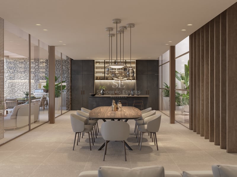 Salle à manger élégante avec table en bois, luminaires design et parois vitrées donnant sur un patio.