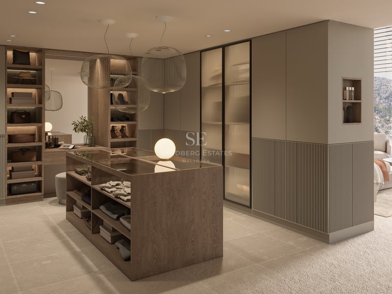 Dressing moderne avec îlot central en bois, armoires en verre strié et élégantes suspensions sphériques.