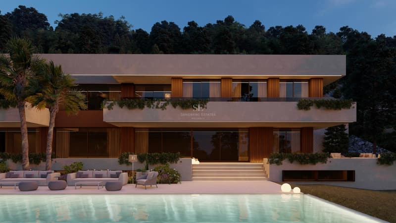 Villa de lujo de diseño contemporáneo con piscina iluminada, zona de estar exterior y vegetación al anochecer.