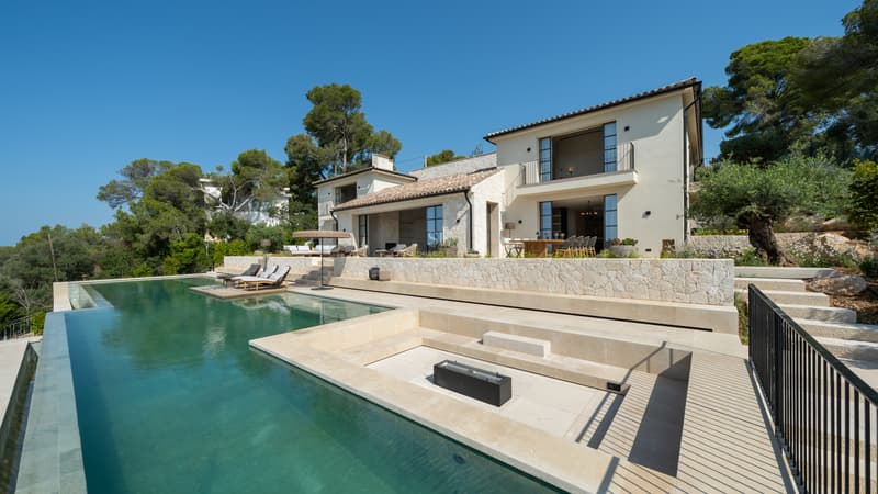 Villa Méditerranéenne Moderne avec Piscine à Débordement Façade de villa de luxe avec piscine à débordement, salon encastré et murs en pierre naturelle.
