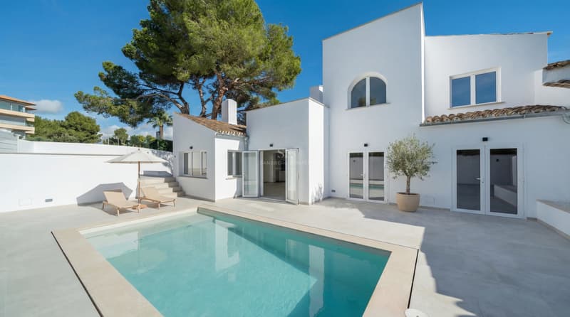 Villa Méditerranéenne Moderne avec Piscine Privée Villa blanche moderne avec piscine turquoise, terrasse en pierre et bains de soleil sous un ciel bleu clair.