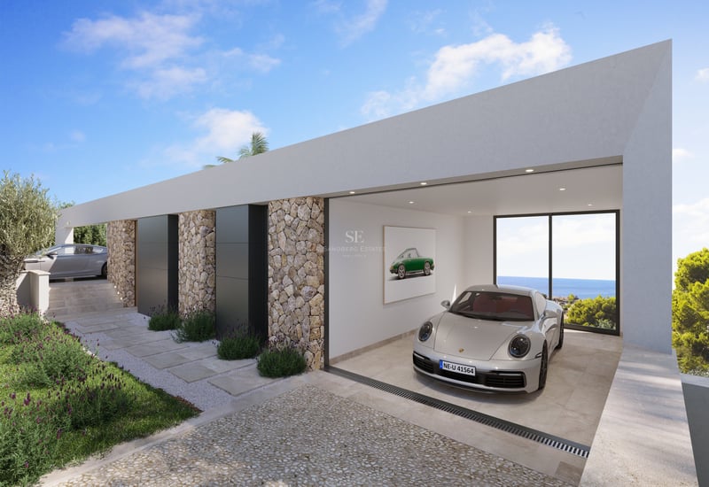 Voiture de sport argentée dans un garage blanc minimaliste avec murs en pierre et baie vitrée donnant sur l'océan.