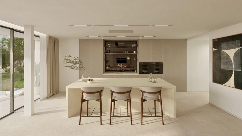Cuisine minimaliste lumineuse avec un grand îlot en pierre, des tabourets de bar et vue sur le jardin.