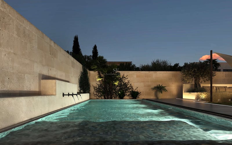 Piscine rectangulaire éclairée avec trois jets d'eau intégrés dans un mur en pierre naturelle au crépuscule.
