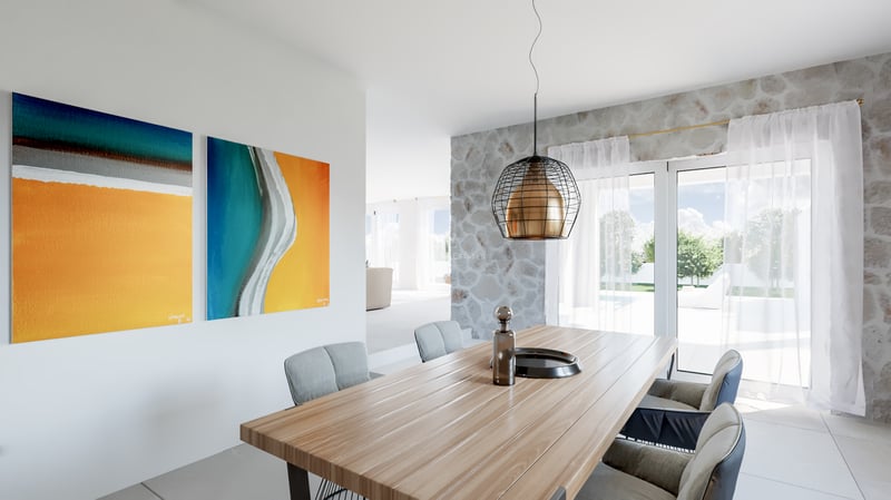 Salle à manger moderne avec table en bois, lampe design, mur en pierre et art abstrait donnant sur une terrasse lumineuse.