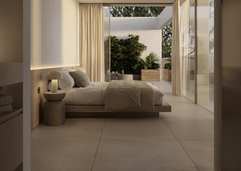 Chambre principale de luxe minimaliste avec lit en bois, carrelage en pierre et baies vitrées vers la terrasse.