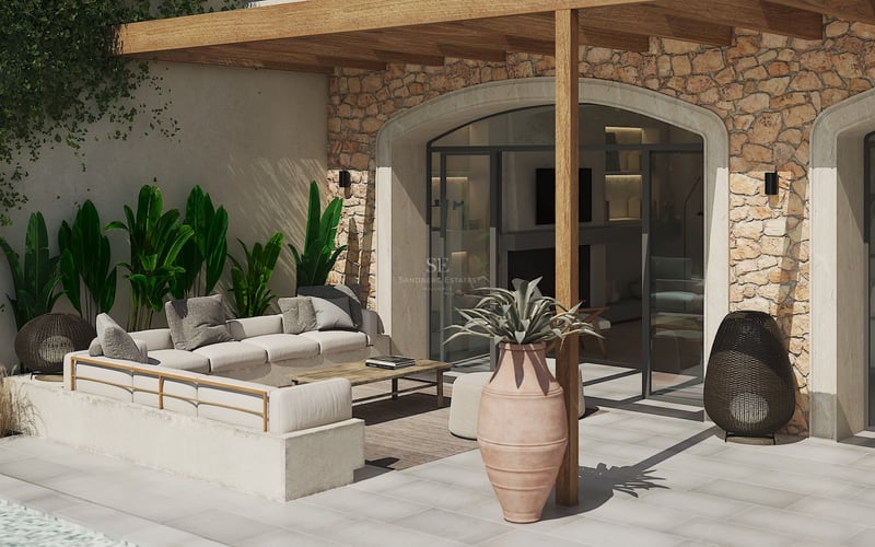 Salón exterior de lujo con sofá integrado, pérgola de madera y pared de piedra natural bajo la luz del sol.