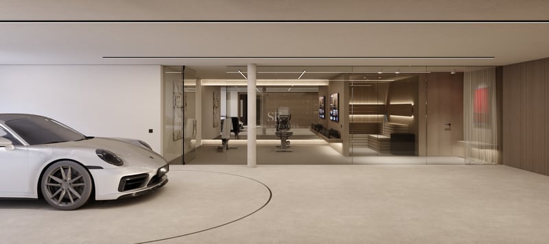 Voiture de sport argentée sur plateforme tournante dans un garage minimaliste avec salle de sport et sauna vitrés.