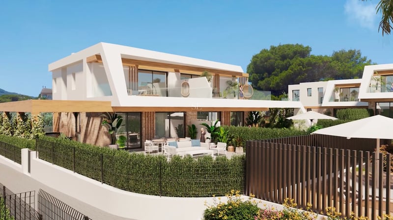 Two-story contemporary villa featuring white geometric lines, natural stone walls, and lush green landscaping.