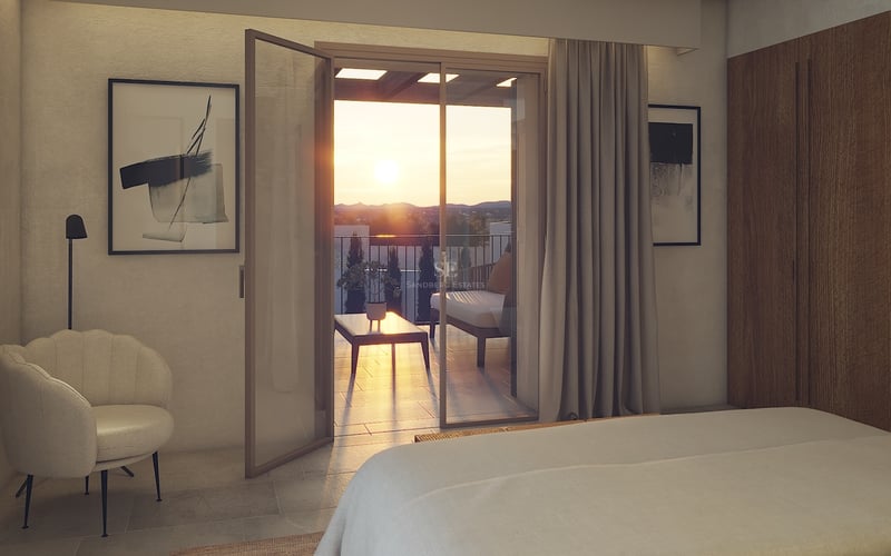 Dormitorio contemporáneo con puertas de cristal a una terraza con vistas al valle durante el atardecer.