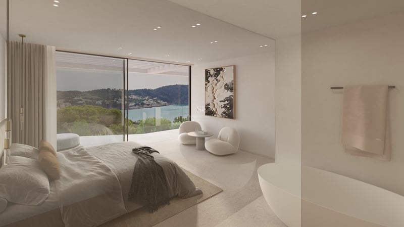 Chambre moderne avec baies vitrées, vue sur la baie, baignoire intégrée et mobilier design aux tons neutres.