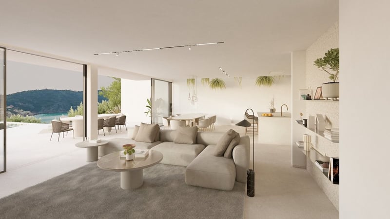 Salon minimaliste ensoleillé avec canapé beige, tables en marbre et grandes baies vitrées ouvrant sur une terrasse.